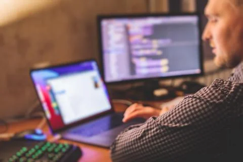 IT developer programmer working and coding on his worplace at home, laptop an Foto stock