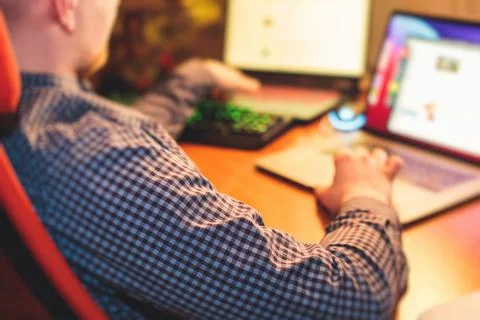 IT developer programmer working and coding on his worplace at home, laptop an Stockfoto's