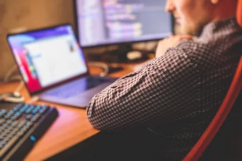 IT developer programmer working and coding on his worplace at home, laptop an Foto stock