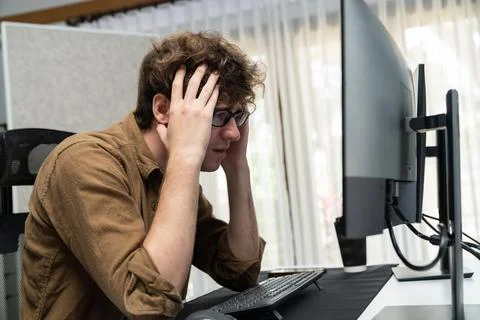 IT developer with stressful overworked having headache in bad feeling. Gusher. Stock Photos
