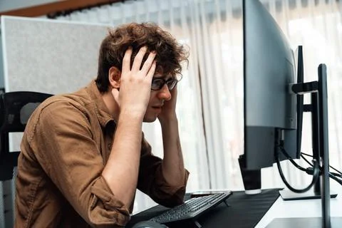 IT developer with stressful overworked having headache in bad feeling. Gusher. Stock Photos