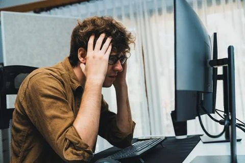 IT developer with stressful overworked having headache in bad feeling. Gusher. Stock Photos