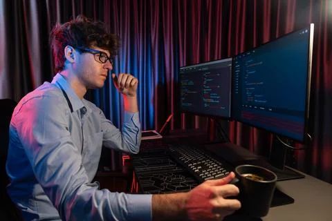 IT developer thinking online software and holding coffee cup. Gusher. Stock Photos