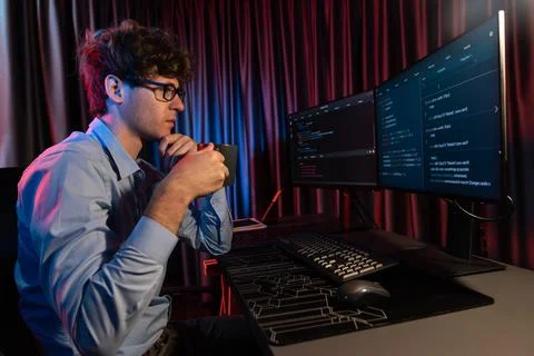 IT developer thinking online software and holding coffee cup. Gusher. Stock Photos