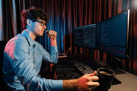 IT developer thinking online software and holding coffee cup. Gusher. Stock Photos