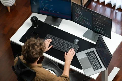 IT developer working online development on pc monitors on top view. Gusher. Stock Photos
