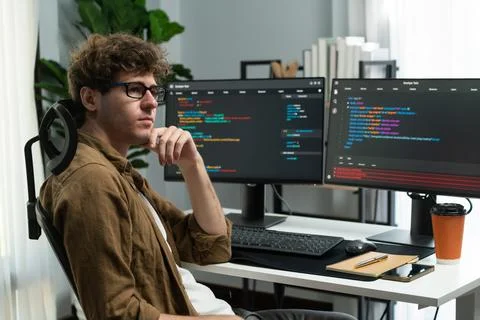 IT developer working online software development coding on pc screens. Gusher. Stock Photos