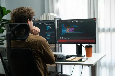 IT developer working online software development coding on pc screens. Gusher. Stock Photos