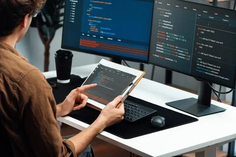 IT developer working online software development coding on pc screens. Gusher. 写真素材