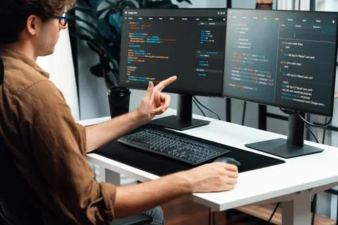 IT developer working online software development coding on pc screens. Gusher. Stock Photos