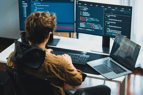 IT developer working online software development coding on pc screens. Gusher. Stock Photos