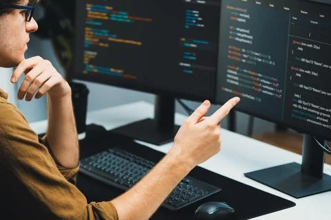 IT developer working online software development coding on pc screens. Gusher. Stock Photos