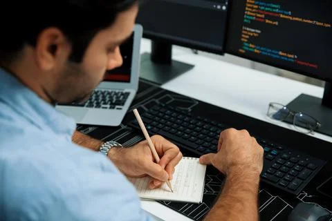 IT developer writing data memo software development on paper's coding. Surmise. 스톡 사진