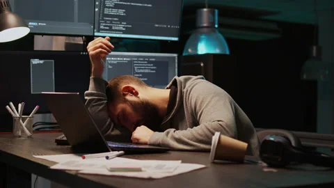 IT developer yawning and falling asleep on desk Stock Footage 222841133
