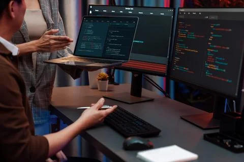 IT developers discussing intelligent website with laptop showing data. Infobahn. Stock Photos