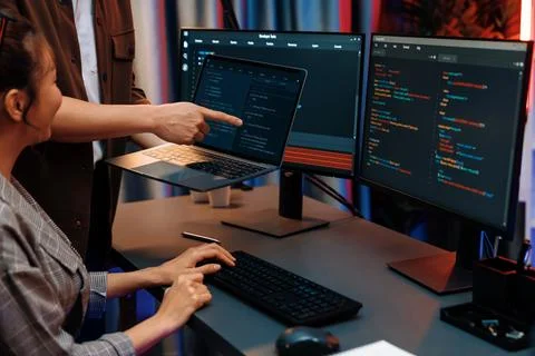 IT developers discussing intelligent website with laptop showing data. Infobahn. Stock Photos