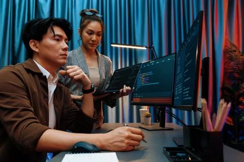 IT developers discussing intelligent website with laptop showing data. Infobahn. Stock Photos