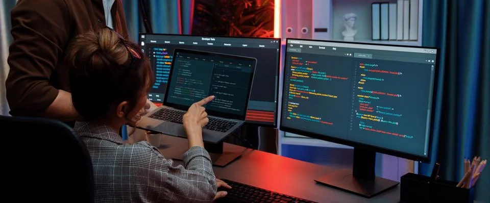 IT developers discussing intelligent website with laptop showing data. Infobahn. Stock Photos