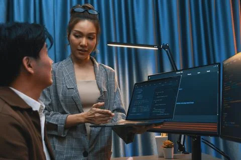 IT developers discussing intelligent website with laptop showing data. Infobahn. Stock Photos