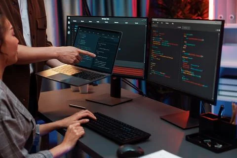 IT developers discussing intelligent website with laptop showing data. Infobahn. Stock Photos