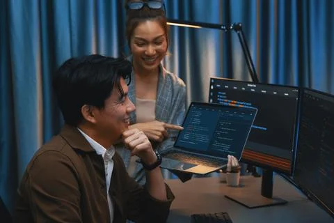 IT developers discussing intelligent website with laptop showing data. Infobahn. Stock Photos