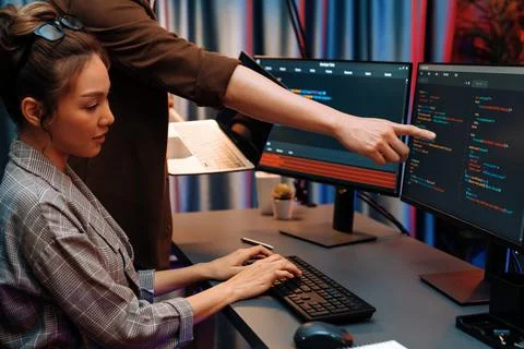 IT developers discussing intelligent website with laptop showing data. Infobahn. Stock Photos