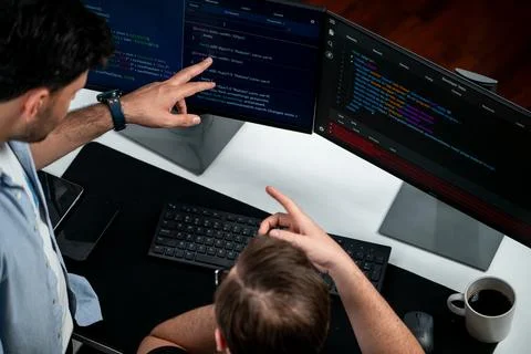 IT developers discussing online software development information. Sellable. Stock Photos