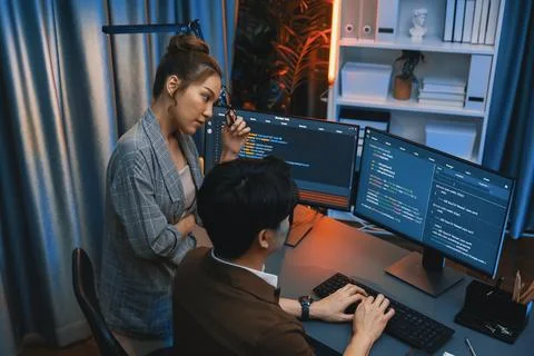 IT developers discussing with point intelligent website development. Infobahn. Stock Photos