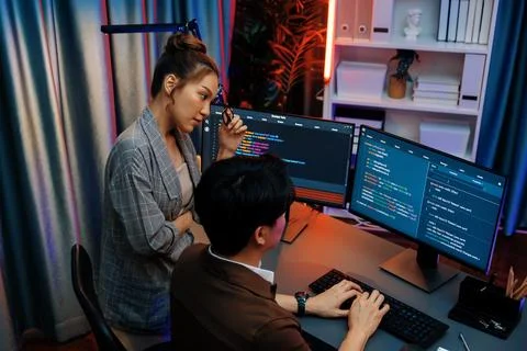 IT developers discussing with point intelligent website development. Infobahn. Stock Photos