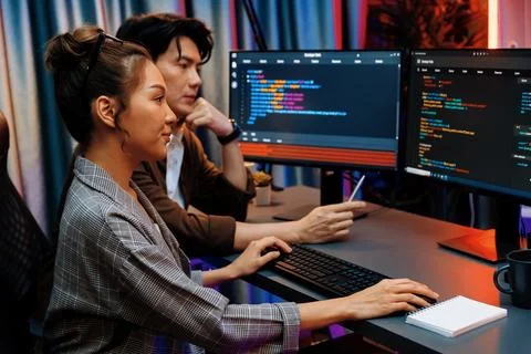 IT developers discussing with point website coding system. Infobahn. Stock Photos