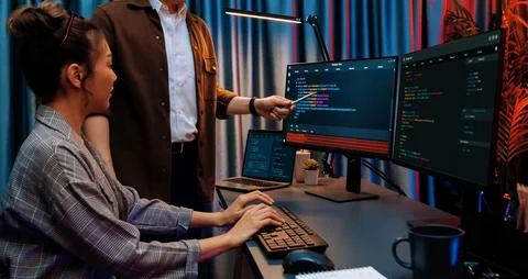 IT developers discussing with point website coding system. Infobahn. Stock Photos