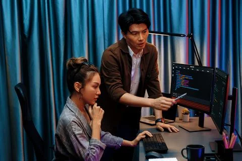 IT developers discussing with point website coding system. Infobahn. Stock Photos