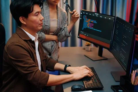 IT developers discussing with point website coding system. Infobahn. Stock Photos