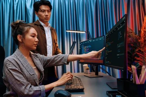 IT developers discussing with point website coding system. Infobahn. Stock Photos