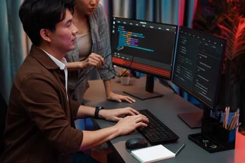 IT developers discussing with point website coding system. Infobahn. Stock Photos