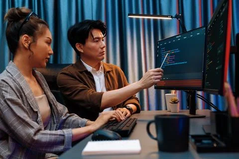 IT developers discussing with point website coding system. Infobahn. Stock Photos