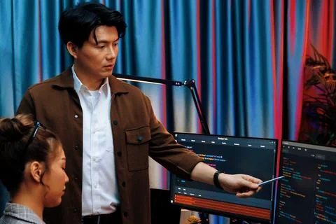 IT developers discussing with point website coding system. Infobahn. Stock Photos