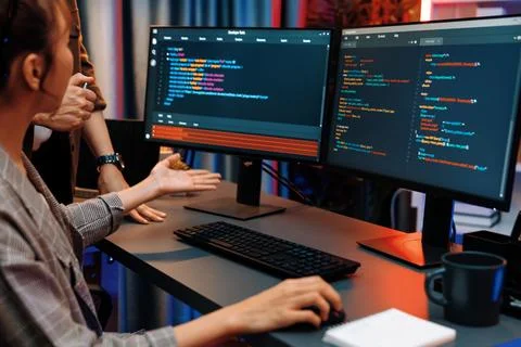 IT developers discussing with point website coding system. Infobahn. Stock Photos