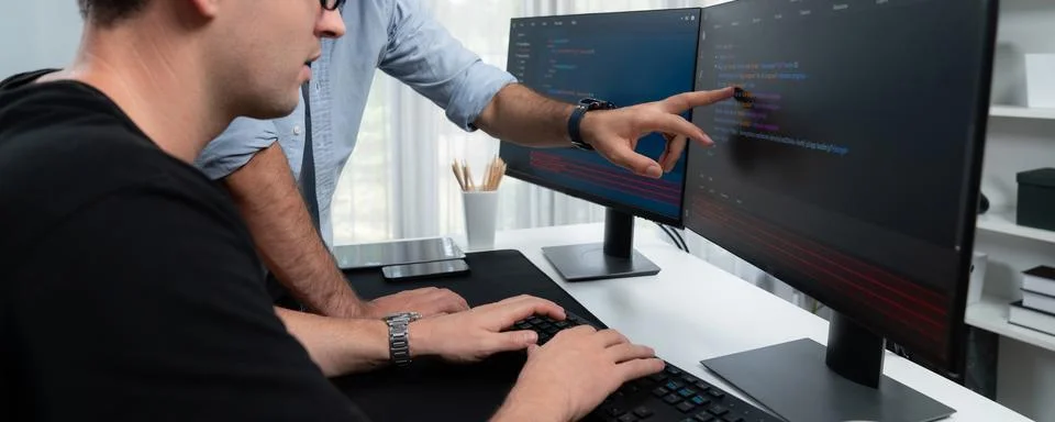 IT developers focusing on development information on panorama view. Sellable. Stock Photos