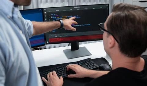 IT developers pointing on software development information. Sellable. Stock Photos