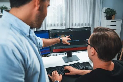 IT developers pointing on software development information. Sellable. Stock Photos