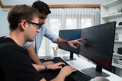 IT developers pointing on software development information. Sellable. Stock Photos