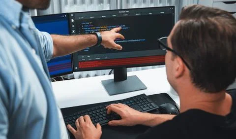 IT developers pointing on software development information. Sellable. Stock Photos