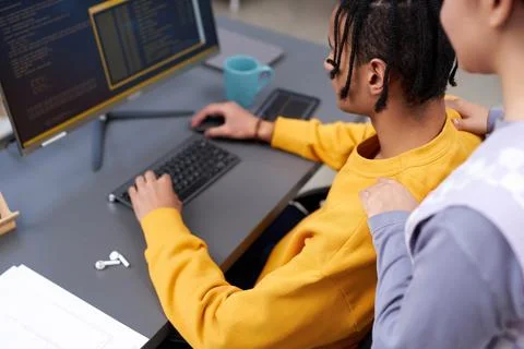 IT developers reviewing code together using compiter Stock Photos