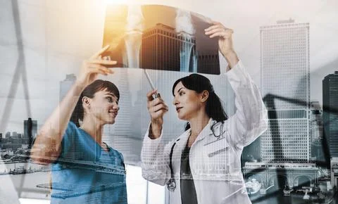 It doesnt hurt to get a second opinion. two doctors discussing the results of an Stock Photos