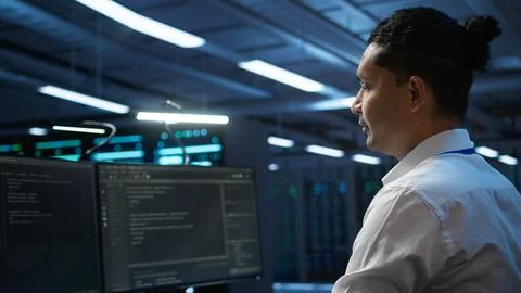 IT employee at work doing maintenance on server room hardware Stock Photos