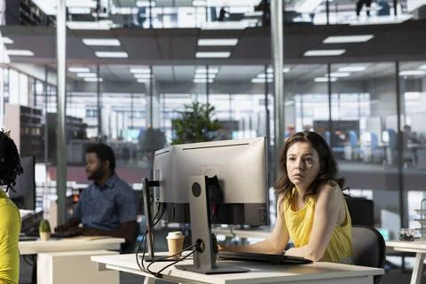 IT employees in office working at computer desks, testing programs Stock Photos