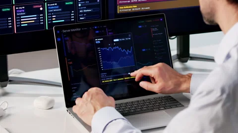 IT Engineer Carefully Monitors Network Performance Using Multiple Tools Stock Footage 333849221