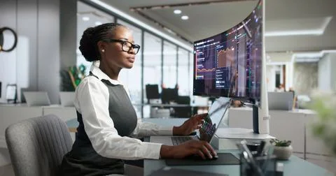 IT Engineer Carefully Tracks Network Uptime And System Performance Remotely. Stock Photos