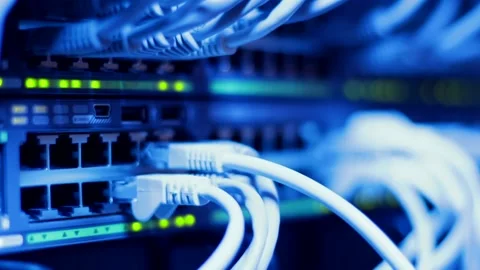 IT engineer connecting client cables to large professional LAN switch Stock Footage 179946090